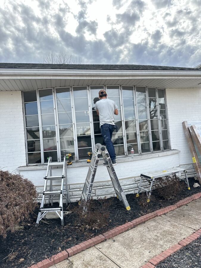 Old curved aluminum bay window before replacement