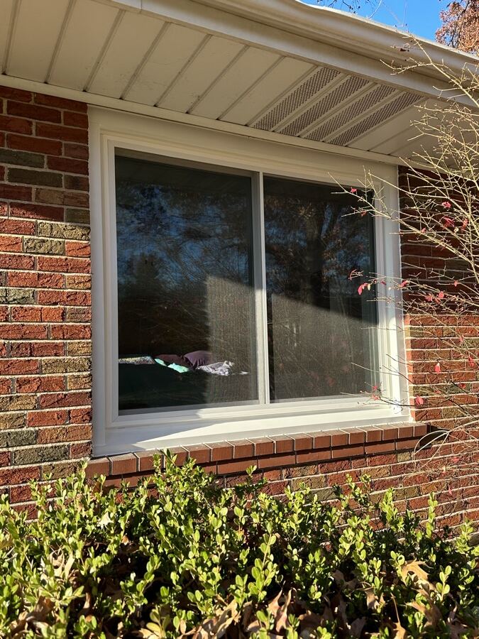 A wide sliding window refit to the original brick opening